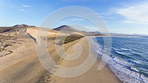 Long white sand beach, dunes, sea waves, Costa Calma, Fuerteventura,