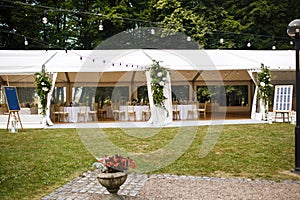 Long white tent for wedding party in the woods