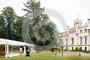 Long white tent for wedding party in the woods