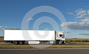 Long white truck on highway