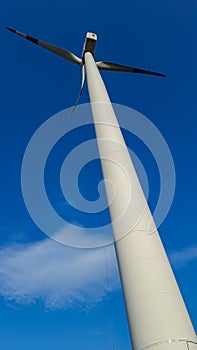 Long wind turbine from an optically interesting oblique view . Frog\'s eye view photographed from the bottom right . photo