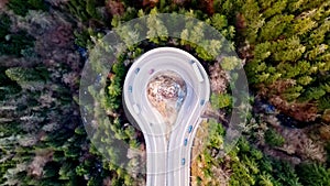 Long Winding U-Shaped Road Slow Aerial Ascent - Moving Traffic Mountain Forest View 4K