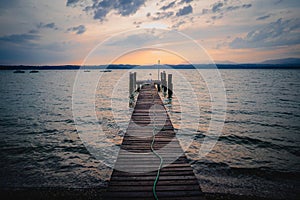 Long wooden Lago di Garda bridge over a lake in Italy photo