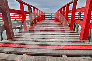 Long Wooden Red Bridge at beach sea , Samut Sakhon ,Thailand