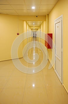 Long yellow hotel corridor