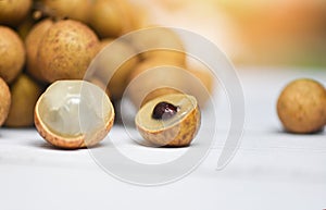 Longan fresh tropical fruit in Thailand - Close up dimocarpus longan peel exotic fruits on white plate on the table