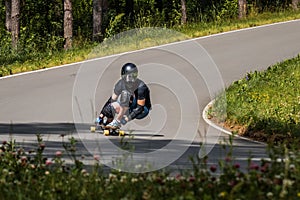 Longboard downhill rider make fast in a turn