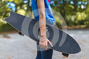 A longboard in the hand of a child