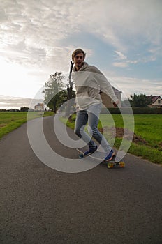 Longboarder going down the hill vertical shot