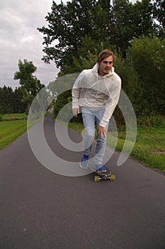 Longboarder going up the hill with speed, vertical shot