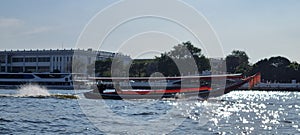 A longboat speeding the waters of the Chao Phraya River in Bangkok, Thailand