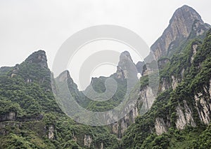 The longest cableway in the world, landscape view with mountains, peaks and the Haven`s Gate Cave within the mist - Tianmen Mount