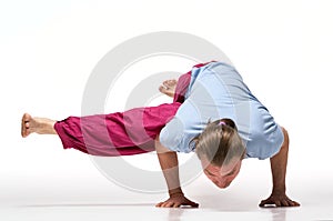 Longhair bearded man working out. Model doing exercis Eka Pada Koundinyasana 2