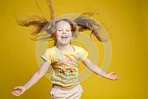 Longhaired girl in cute shirt playing with hair and twirling