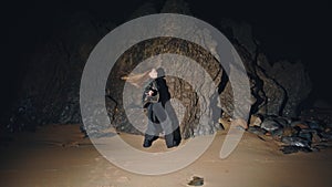 Longhaired model stepping sand beach at night back view. Woman dance festival