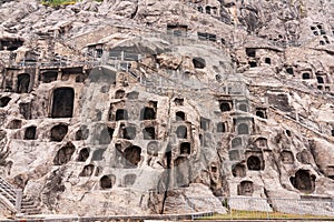 Longmen Grottoes hillside with carved Buddha statues caves, Luoyang, China