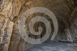 Buddha sculpture in cave interior of Luoyang Longmen Grottoes, Henan, China