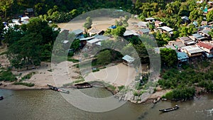 Longneck karen village in the mountain with boat on the river. Mae Hong Son, Thailand. Aerial Shot