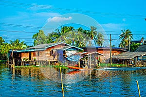 Longtail Boat Adventure: Navigating the Canal Village under a Calm Blue Summer Sky