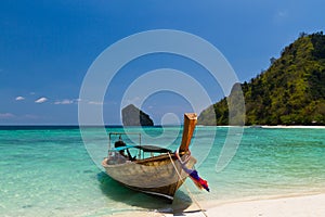 Longtail boat on beach photo