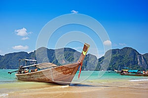 Longtail boat in the beautiful sea over clear sky