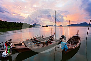 longtail boat with coastal fishing village ,Beautiful morning sunrise over sea and mountain in phang - nga thailand