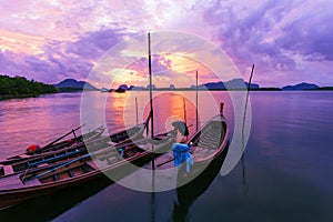 Longtail boat with coastal fishing village ,Beautiful scenery morning sunrise over sea and mountain in phang - nga thailand