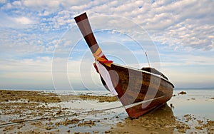 Longtail boat in low tide photo