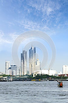 Longtail Boat Tours on Chaophraya river and bangkok cityscape background, is favorite activities of tourists