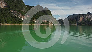 Longtail boat travelling on a lake