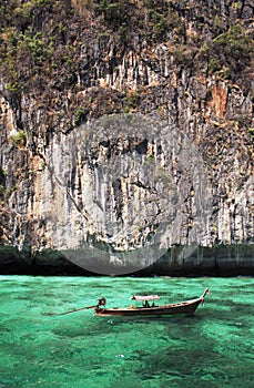 Longtail boat in turquoise waters photo