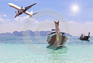 Longtail boats on andaman tropical sea in Thailand with airplane landing