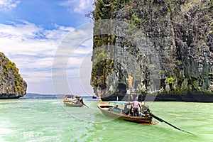 Longtail boats with tourists near famous place in Phang Nga bay near James Bond island, Phuket.