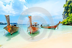 Longtale boat on the white beach at Phuket, Thailand. Phuket is a popular destination famous for its beaches