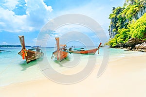 Longtale boat on the white beach at Phuket, Thailand. Phuket is a popular destination famous for its beaches