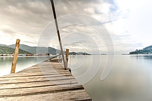 Longtime exposure at wooden jetty close to a pier