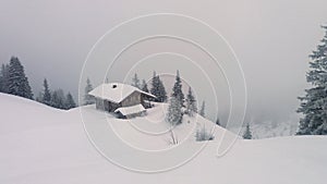 Lonly mountain hut under snow