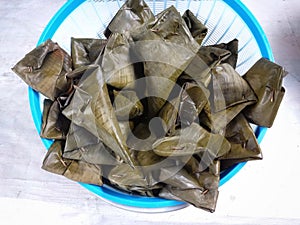 Lontong is a typical Indonesian dish made from compressed triangular rice cake wrapped inside a banana leaf.