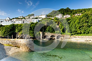 Looe harbour wall Cornwall England with blue green sea