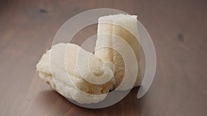 Loofah sponge on walnut wood table, slide shot