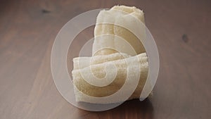 Loofah sponge on walnut wood table, slide shot