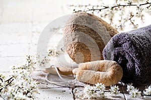 Loofah and towel over fresh flowers for exfoliation spa treatment