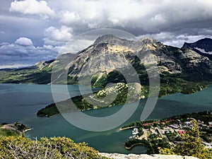 A look above on the town of Waterton on a dark cloudy day, at the top of bear`s hump trail in Waterton Lakes National Park