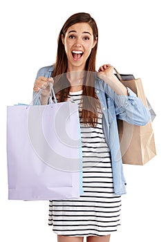 Look at all the bargains I got. Studio shot of a beautiful young woman holding shopping bags against a white background.