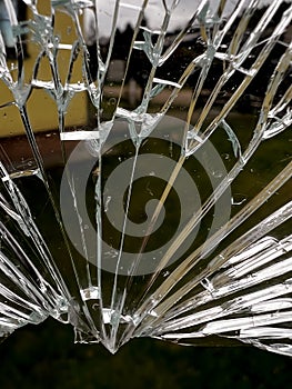 A look through cracked tempered glass, a broken pot lid before being thrown away