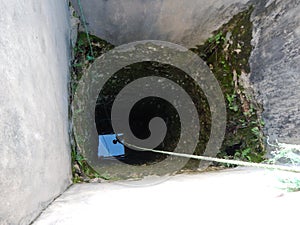 Look into a deep well with water