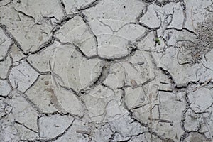 Look down on crack dried mud surface of the ground.