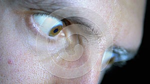 Look of Fear, Bulging Eyes of a Young Man on a Black Background