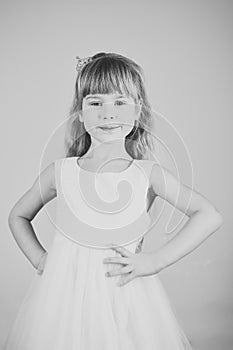 Look, hairdresser, makeup. Child girl in stylish glamour dress, elegance. Fashion model on pink background, beauty