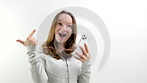 Look Here. Happy Woman Showing Blank Smartphone Screen and Pointing On It, white Background